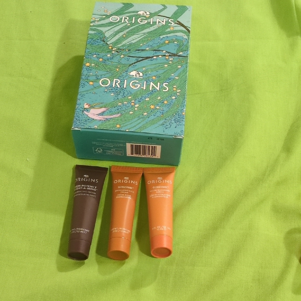 Origins Skincare Trio with Brown, Orange, and Pink Tubes